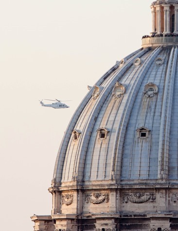 The helicopter carrying Pope Benedict passes the dome of St. Peter's Basilica February 28.  Pilot photo/Gregory L.  Tracy